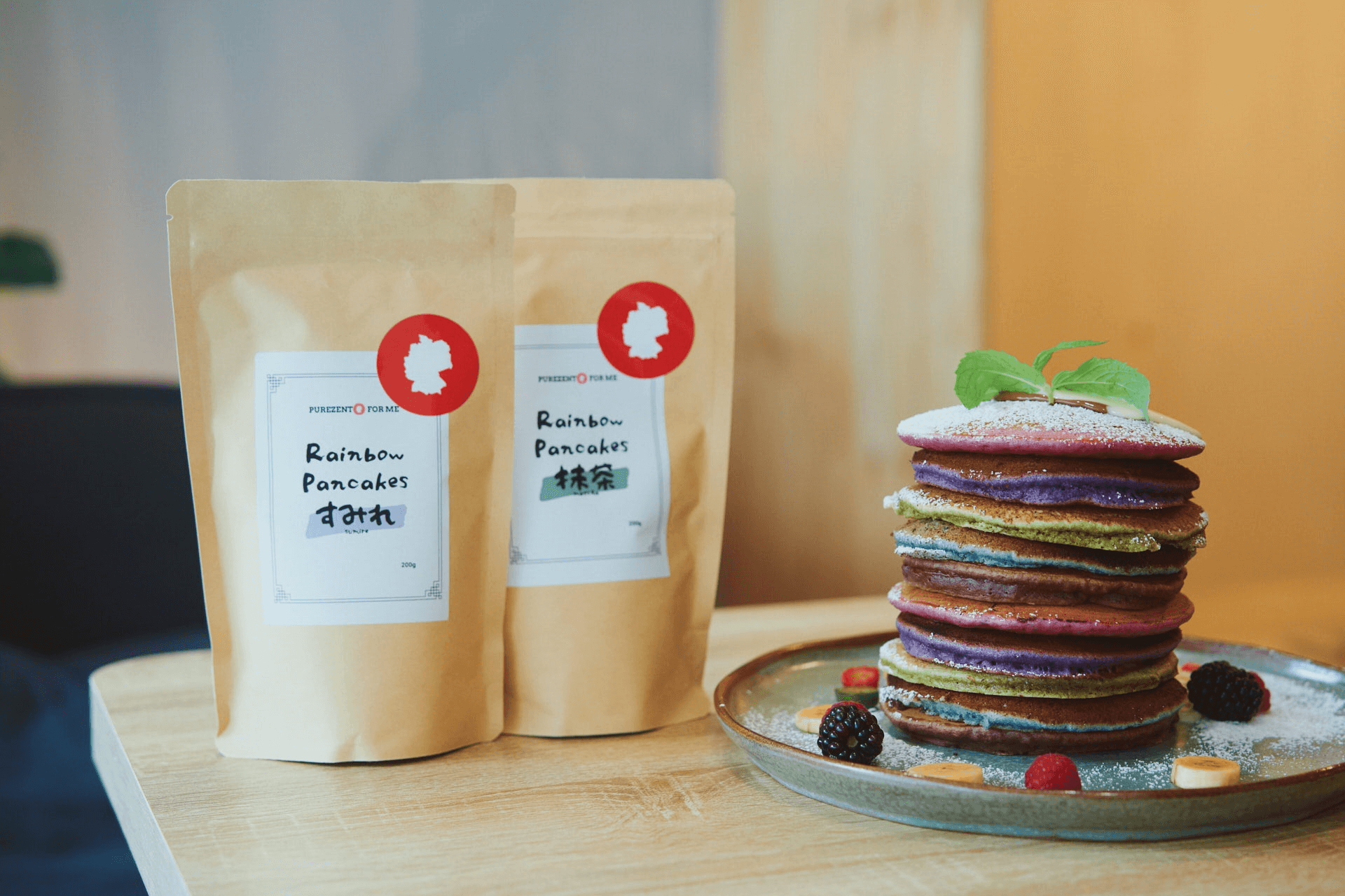 Rainbow pancakes on a plate with purezento for me packages behind for website collection image www.purezentoforme.com